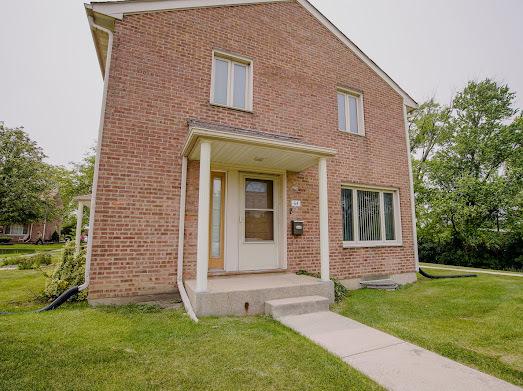 64 Ash St, Park Forest, IL 60466 - view of front of house featuring a front yard and brick siding