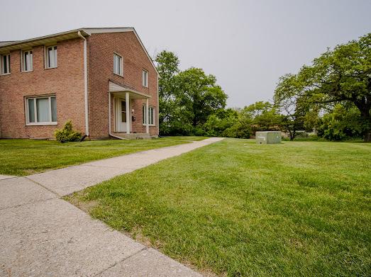 64 Ash St, Park Forest, IL 60466 - view of side of property featuring a lawn and brick siding