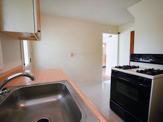 64 Ash St, Park Forest, IL 60466 - kitchen featuring range with gas stovetop, a sink, and light flooring