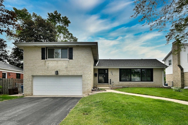 771 S Euclid Ave, Elmhurst, IL 60126 - split level home with a garage, brick siding, asphalt driveway, and cooling unit