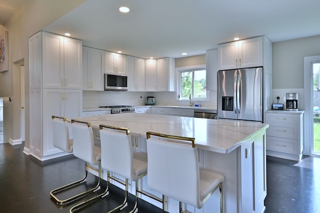 771 S Euclid Ave, Elmhurst, IL 60126 - kitchen with stainless steel appliances, white cabinetry, light stone counters, tasteful backsplash, and a kitchen island