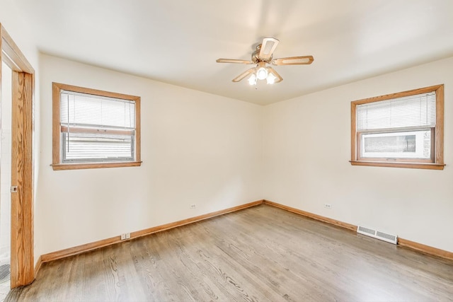 3645 W 66th St, Chicago, IL 60629 - spare room with wood finished floors, baseboards, and ceiling fan
