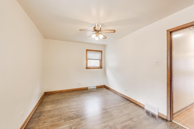 3645 W 66th St, Chicago, IL 60629 - spare room featuring a ceiling fan, wood finished floors, and baseboards
