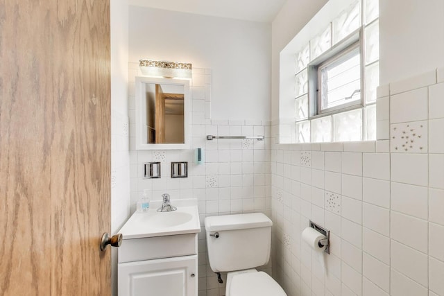 3645 W 66th St, Chicago, IL 60629 - half bathroom with vanity, toilet, and tile walls