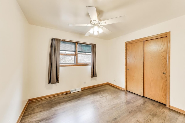 3645 W 66th St, Chicago, IL 60629 - unfurnished bedroom featuring light wood-type flooring, a closet, baseboards, and ceiling fan