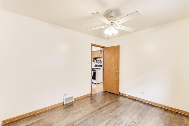 3645 W 66th St, Chicago, IL 60629 - empty room with light wood finished floors, baseboards, and ceiling fan