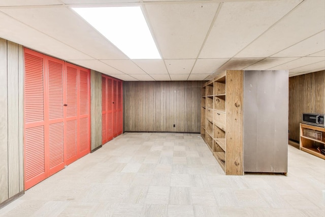 3645 W 66th St, Chicago, IL 60629 - finished basement featuring wooden walls, light floors, and a paneled ceiling