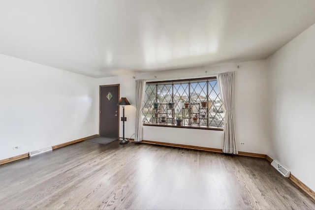 3645 W 66th St, Chicago, IL 60629 - unfurnished living room featuring wood finished floors and baseboards
