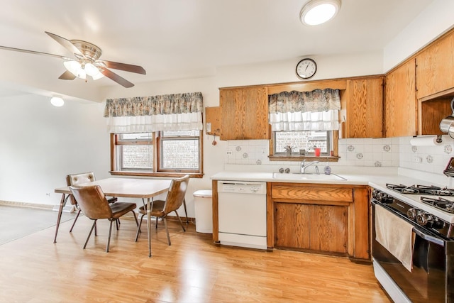 3645 W 66th St, Chicago, IL 60629 - kitchen featuring white dishwasher, gas range, a sink, light countertops, and ceiling fan