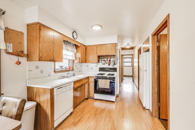 3645 W 66th St, Chicago, IL 60629 - kitchen featuring white appliances, light wood-style floors, tasteful backsplash, light countertops, and brown cabinets