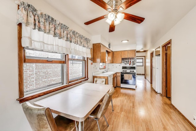 3645 W 66th St, Chicago, IL 60629 - dining area with light wood finished floors, ceiling fan, and baseboards