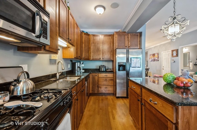1849 W Newport Ave Unit 1, Chicago, IL 60657 - kitchen with stainless steel appliances, light wood-style floors, crown molding, brown cabinets, and dark stone countertops