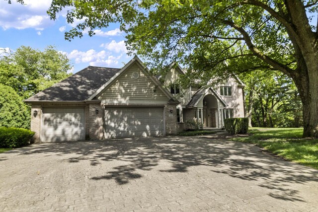 2 Lake Metonga Trl, Grant Park, IL 60940 - traditional-style home featuring asphalt driveway, brick siding, and a garage