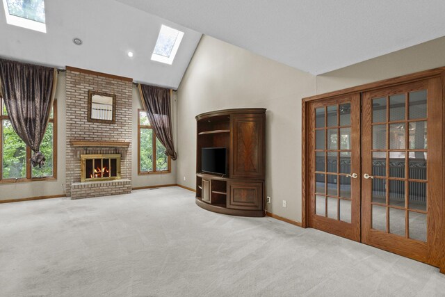 2 Lake Metonga Trl, Grant Park, IL 60940 - unfurnished living room with a skylight, french doors, light carpet, high vaulted ceiling, and a brick fireplace