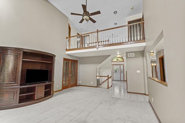 2 Lake Metonga Trl, Grant Park, IL 60940 - unfurnished living room with french doors, carpet floors, a ceiling fan, and a towering ceiling