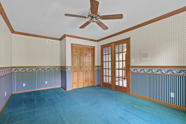 2 Lake Metonga Trl, Grant Park, IL 60940 - carpeted empty room featuring crown molding, french doors, wainscoting, a ceiling fan, and wallpapered walls