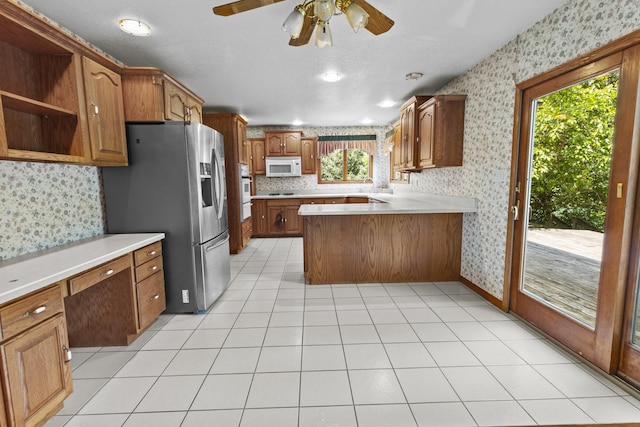 2 Lake Metonga Trl, Grant Park, IL 60940 - kitchen with white appliances, wallpapered walls, a ceiling fan, brown cabinets, and a peninsula