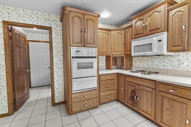 2 Lake Metonga Trl, Grant Park, IL 60940 - kitchen featuring white appliances, wallpapered walls, a warming drawer, and brown cabinets