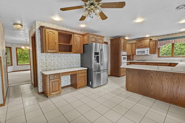 2 Lake Metonga Trl, Grant Park, IL 60940 - kitchen with white appliances, light countertops, built in desk, brown cabinetry, and open shelves