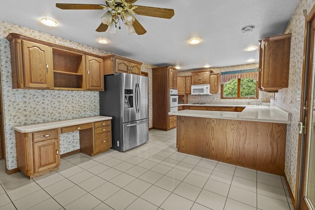 2 Lake Metonga Trl, Grant Park, IL 60940 - kitchen featuring white appliances, wallpapered walls, light countertops, built in study area, and a peninsula