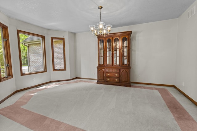 2 Lake Metonga Trl, Grant Park, IL 60940 - carpeted empty room with a chandelier and baseboards