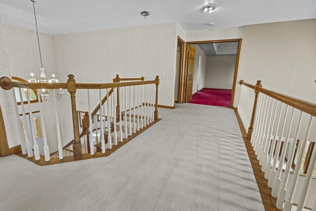 2 Lake Metonga Trl, Grant Park, IL 60940 - hall featuring an upstairs landing, a chandelier, carpet, and wallpapered walls