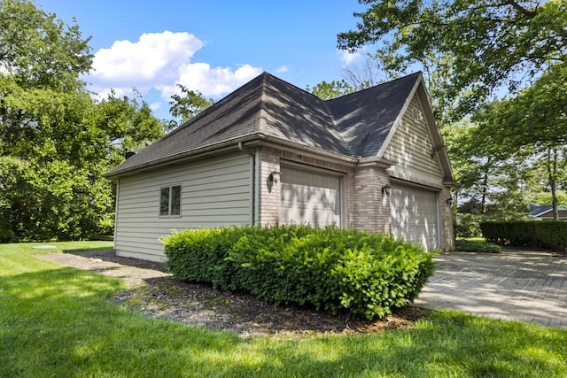 2 Lake Metonga Trl, Grant Park, IL 60940 - view of side of home with a garage, roof with shingles, a lawn, and brick siding