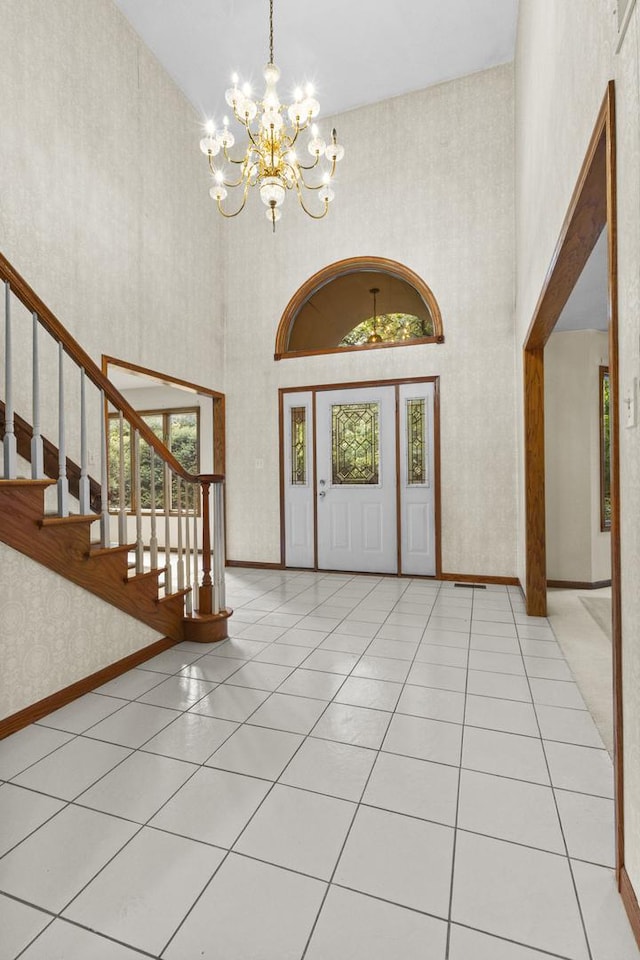 2 Lake Metonga Trl, Grant Park, IL 60940 - tiled entrance foyer with a high ceiling, a chandelier, stairs, and wallpapered walls