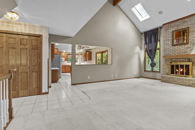 2 Lake Metonga Trl, Grant Park, IL 60940 - unfurnished living room with high vaulted ceiling, light carpet, a skylight, light tile patterned flooring, and a brick fireplace