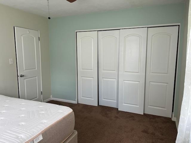 114 Dante Ct, Shorewood, IL 60404 - bedroom with dark colored carpet, a closet, baseboards, and ceiling fan