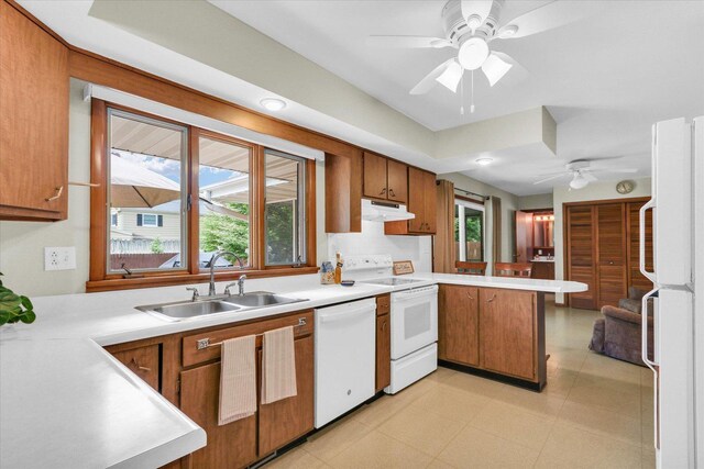 1207 W Kirby Ave, Champaign, IL 61821 - kitchen with white appliances, a peninsula, a ceiling fan, and light countertops