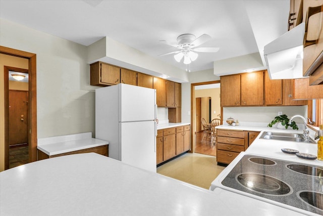 1207 W Kirby Ave, Champaign, IL 61821 - kitchen with freestanding refrigerator, brown cabinetry, ceiling fan, and light countertops
