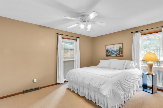 1207 W Kirby Ave, Champaign, IL 61821 - bedroom with light colored carpet, multiple windows, and ceiling fan
