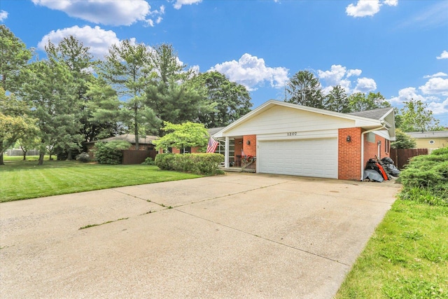 1207 W Kirby Ave, Champaign, IL 61821 - view of front of property with brick siding, a garage, and concrete driveway