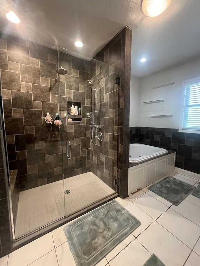 1131 S Nelson Ave, Kankakee, IL 60901 - bathroom with a whirlpool tub, a stall shower, tile patterned flooring, a textured ceiling, and recessed lighting