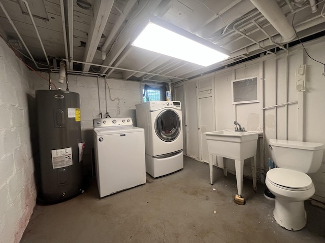 1131 S Nelson Ave, Kankakee, IL 60901 - unfinished below grade area with electric water heater, washer and clothes dryer, and concrete block wall