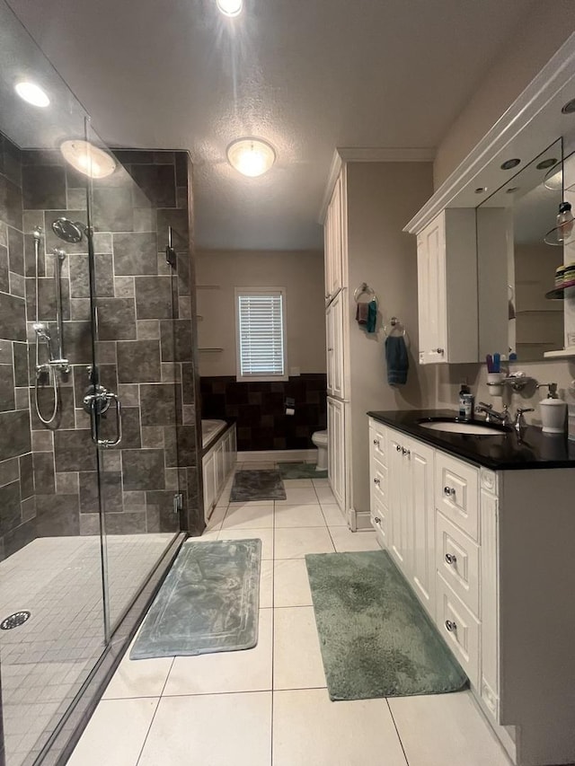 1131 S Nelson Ave, Kankakee, IL 60901 - bathroom with a shower stall, vanity, tile patterned flooring, toilet, and a textured ceiling
