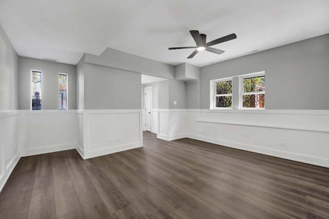 849 W Belle Plaine Ave Unit G, Chicago, IL 60613 - empty room with dark wood finished floors, wainscoting, ceiling fan, and a decorative wall