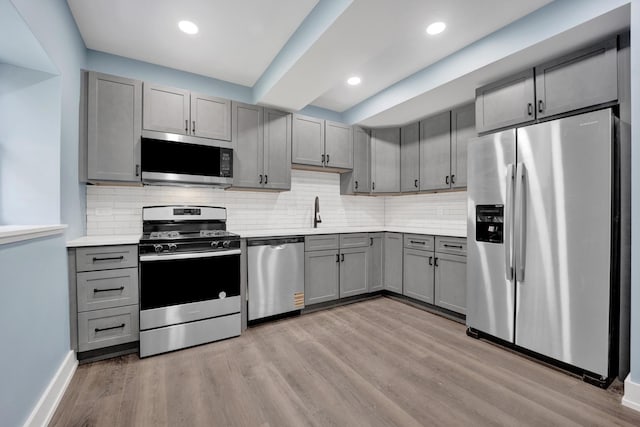 849 W Belle Plaine Ave Unit G, Chicago, IL 60613 - kitchen featuring appliances with stainless steel finishes, gray cabinets, light countertops, light wood-type flooring, and recessed lighting