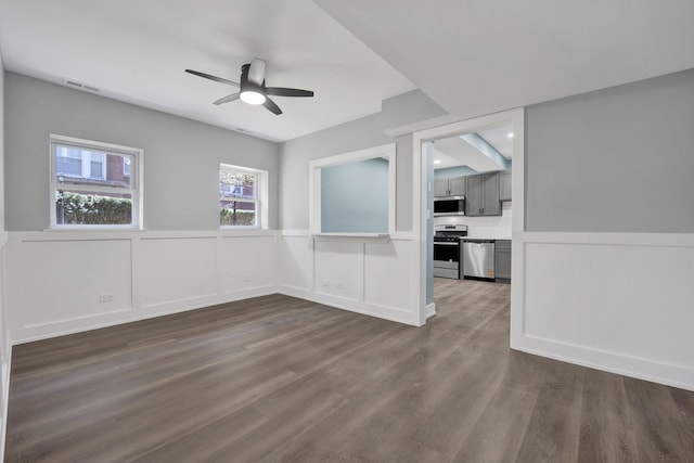 849 W Belle Plaine Ave Unit G, Chicago, IL 60613 - unfurnished room featuring a ceiling fan, dark wood-style floors, and wainscoting
