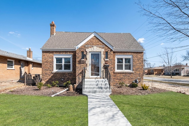 9841 Cook Ave, Oak Lawn, IL 60453 - view of front of property with a front yard, brick siding, and a shingled roof