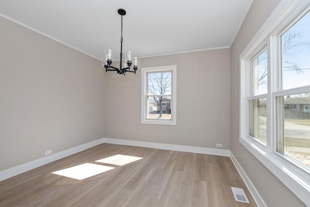9841 Cook Ave, Oak Lawn, IL 60453 - empty room with a chandelier, ornamental molding, light wood-type flooring, and baseboards