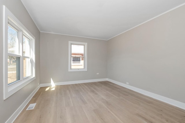 9841 Cook Ave, Oak Lawn, IL 60453 - unfurnished room featuring light wood-type flooring, plenty of natural light, baseboards, and crown molding