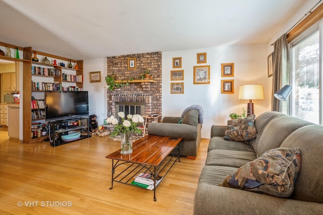 608 N Craig Pl, Addison, IL 60101 - living room with light wood-type flooring and a brick fireplace