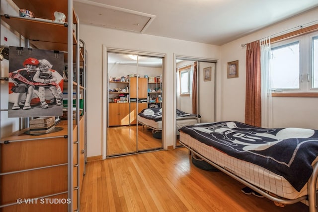 608 N Craig Pl, Addison, IL 60101 - bedroom featuring light wood-style floors, multiple closets, and multiple windows
