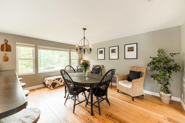 707 Coolidge Pl, Rockford, IL 61107 - dining space with light wood-type flooring, baseboards, and a chandelier