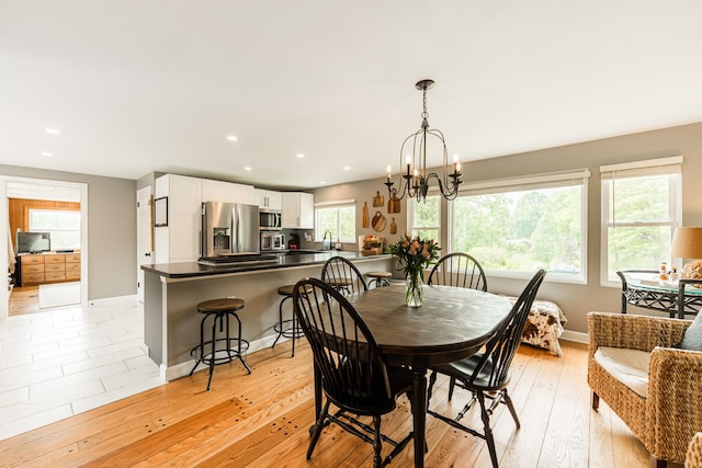 707 Coolidge Pl, Rockford, IL 61107 - dining area with a chandelier, recessed lighting, baseboards, and light wood finished floors