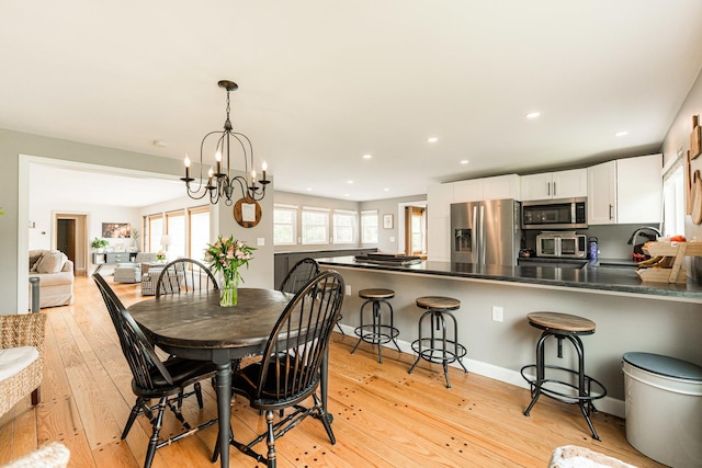 707 Coolidge Pl, Rockford, IL 61107 - dining area with light wood-style floors, a chandelier, and recessed lighting