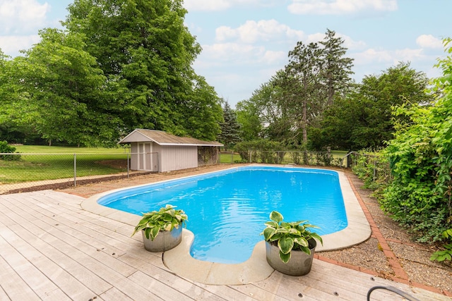 707 Coolidge Pl, Rockford, IL 61107 - view of pool featuring a fenced backyard, a deck, and view of scattered trees