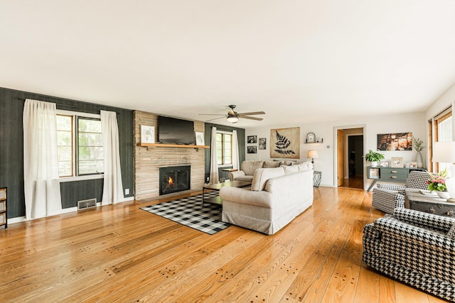 707 Coolidge Pl, Rockford, IL 61107 - living room with light wood-style floors, a ceiling fan, and a brick fireplace